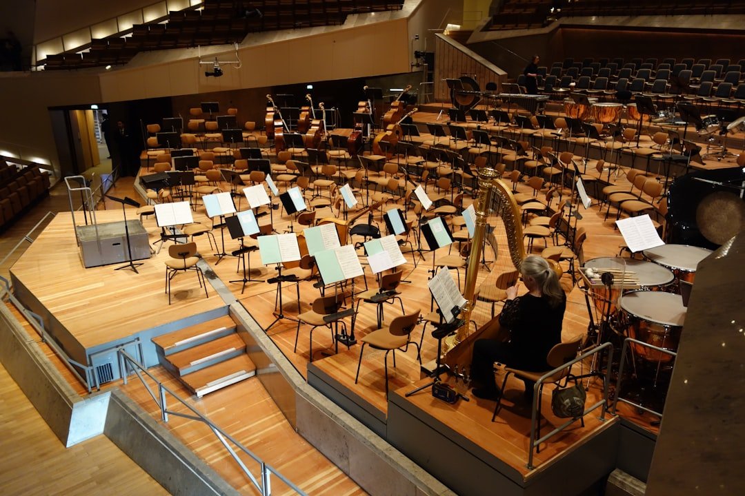 a-person-playing-the-piano-in-a-large-room-with-many-tables-and-chairs-dbn9y8sisbc